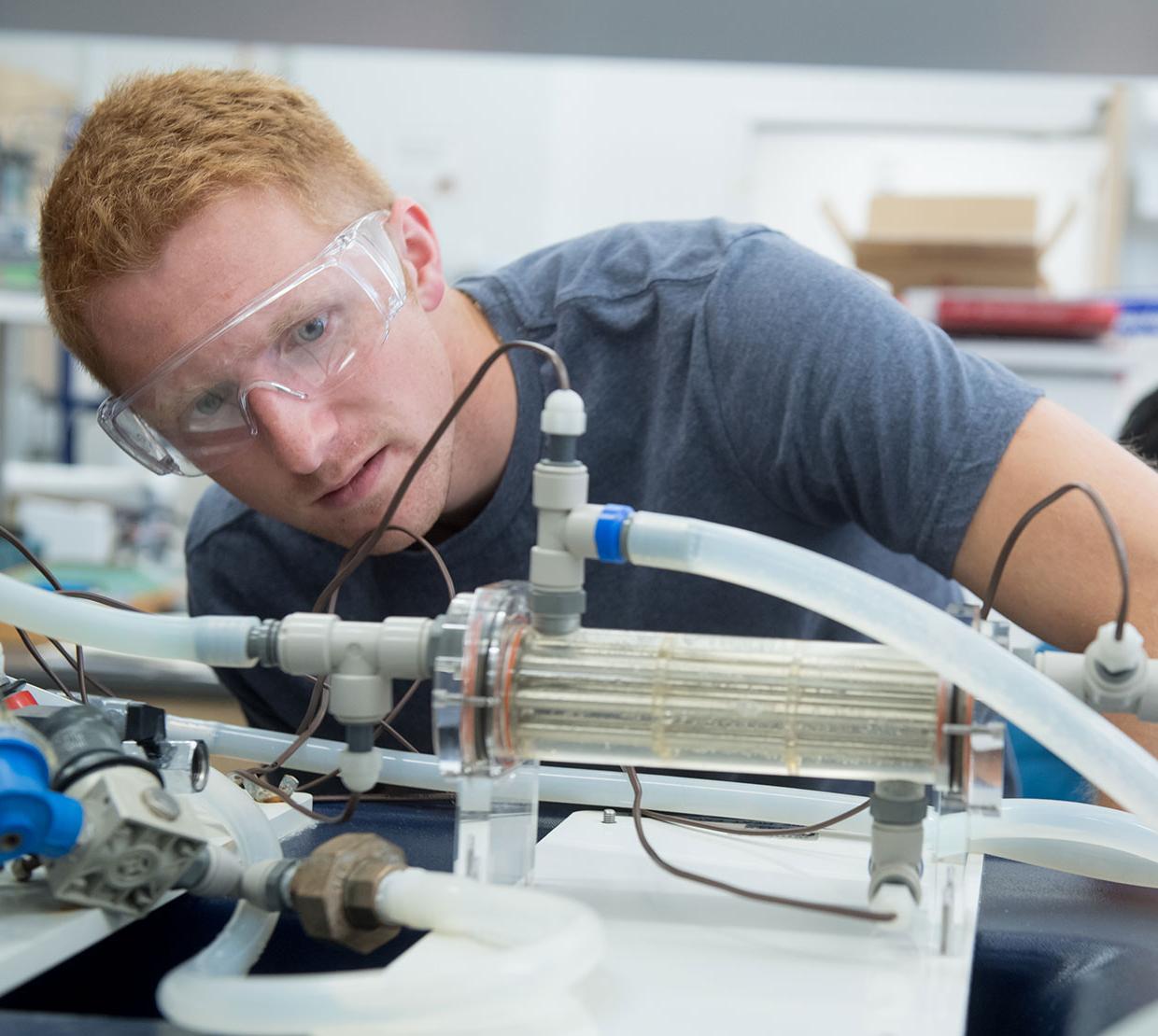 male student working with lab equipment