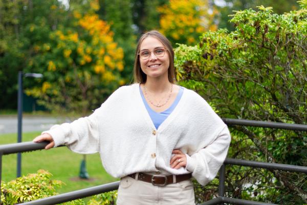 Jane Shaw MacDonald standing outside in front of some trees.