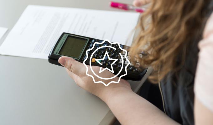 star icon above image of student working on homework with calculator