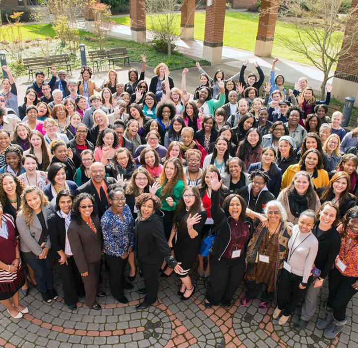 female conference attendees taking group photo outside